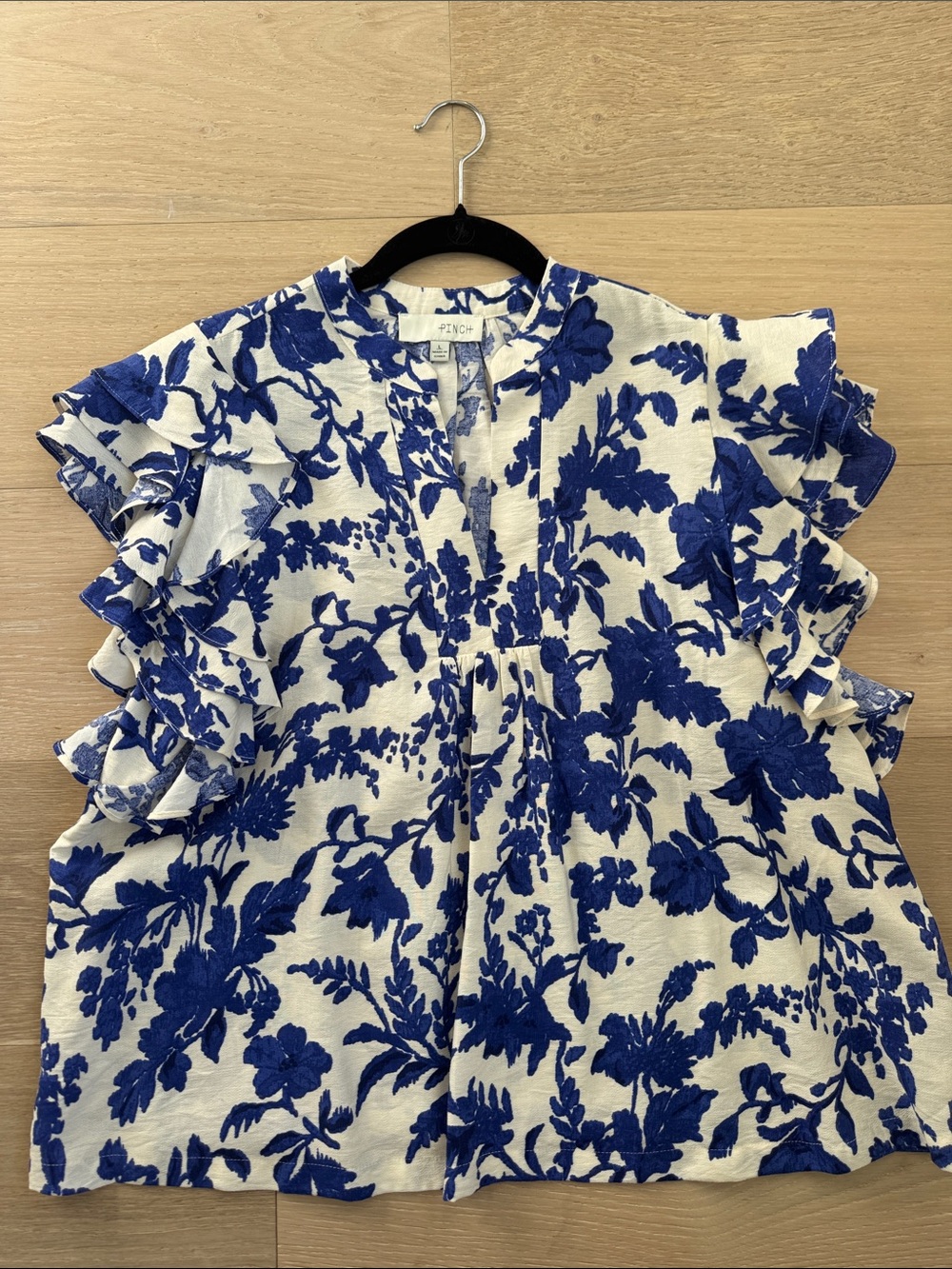 White Top with Bold Blue Floral Print and Ruffle Sleeves